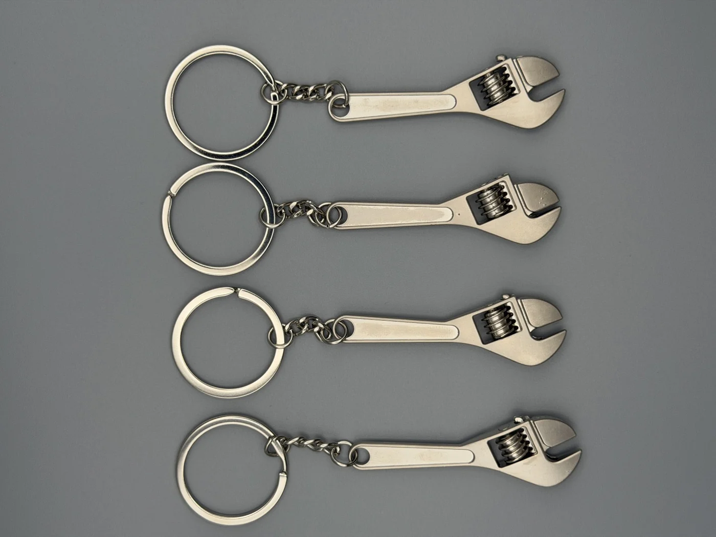 Four SHOP GHXST adjustable wrench keychains