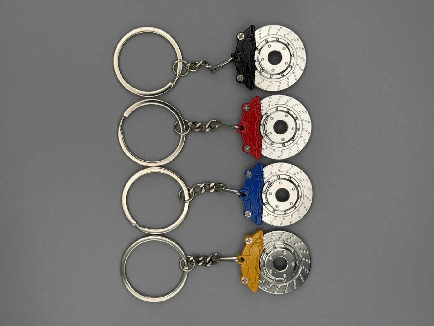 All four SHOP GHXST brake rotor keychain colors