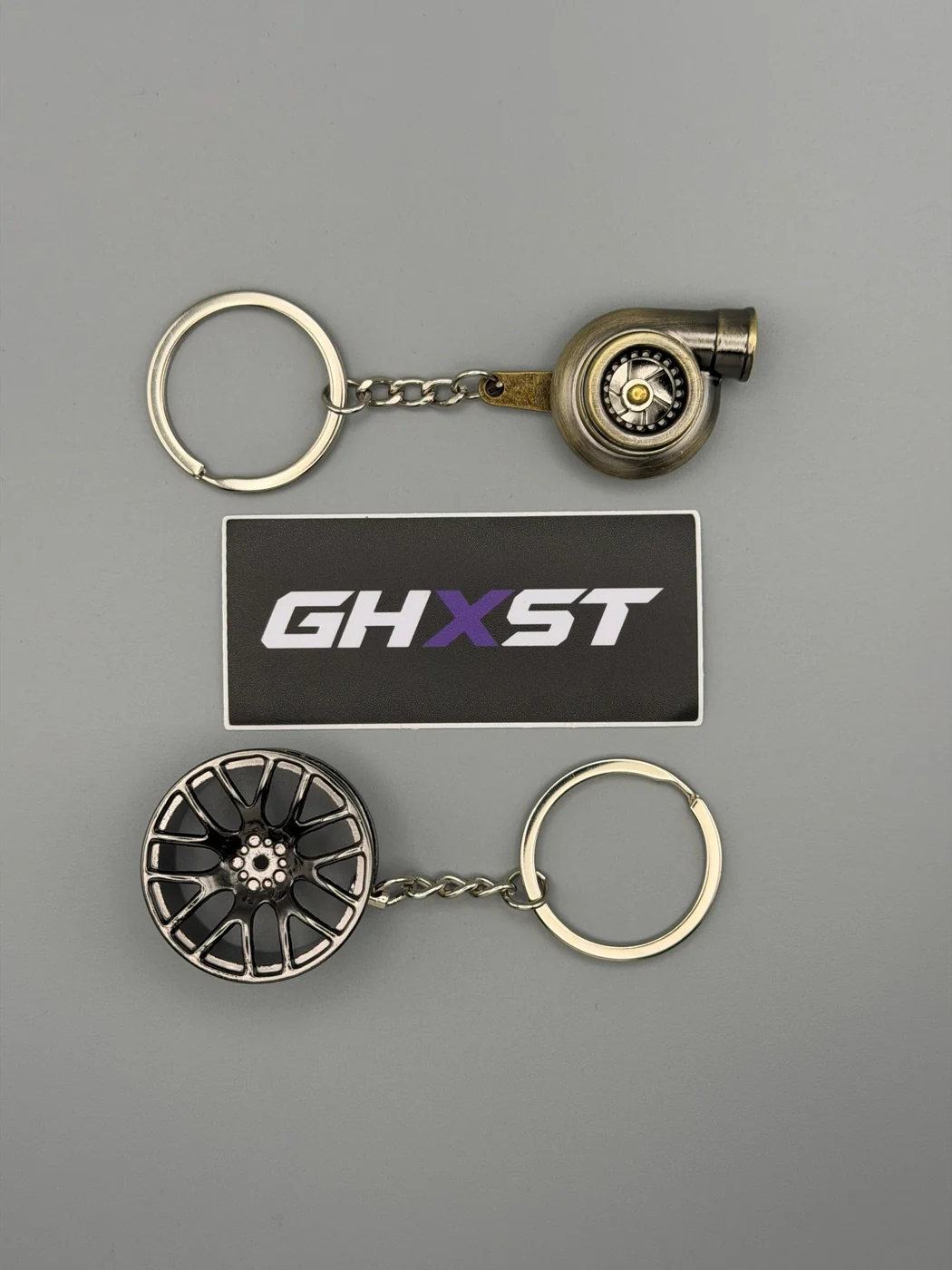 Turbo and wheel keychains arranged with a SHOP GHXST brand card