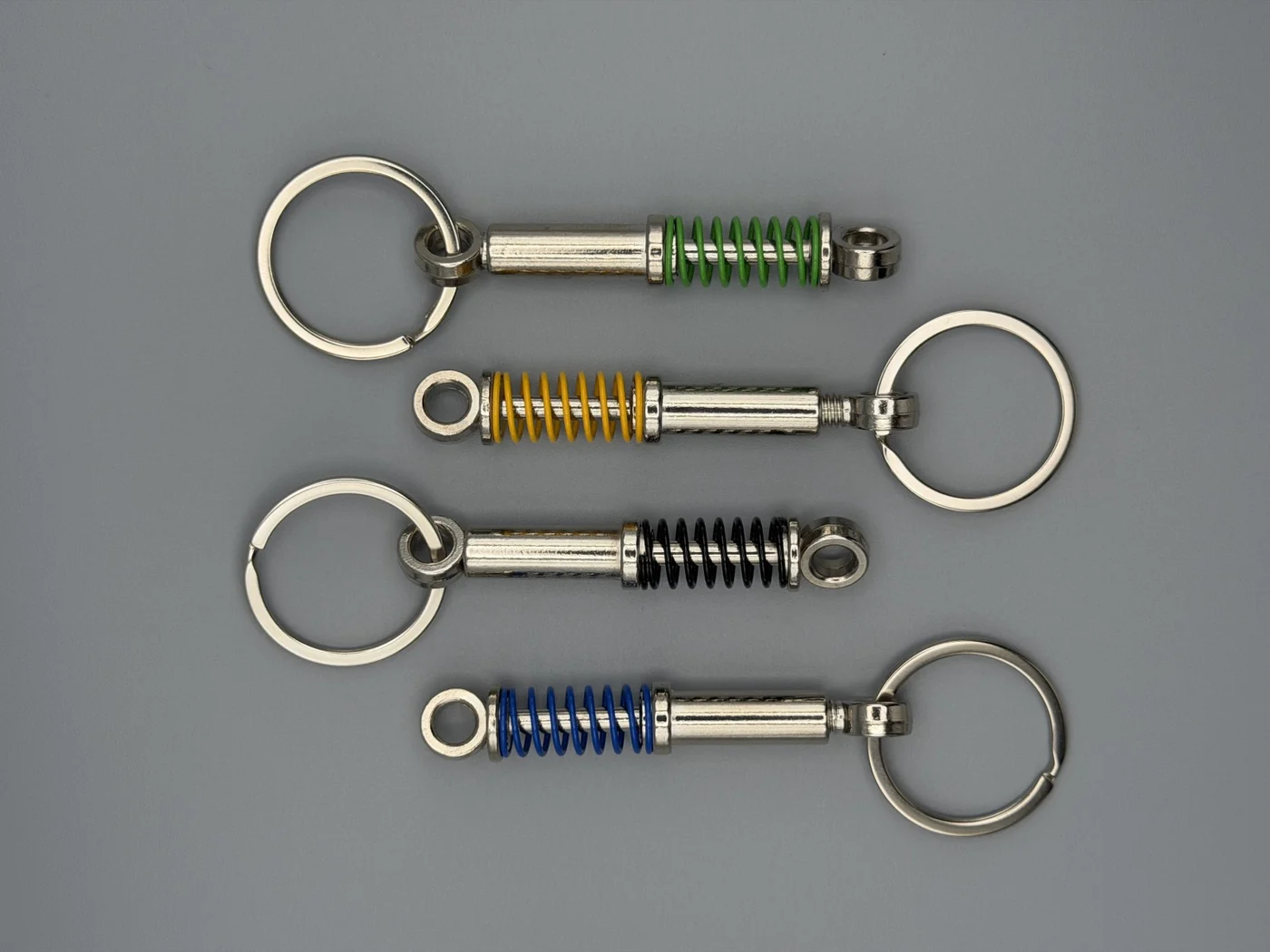 All four SHOP GHXST coilover keychain colors