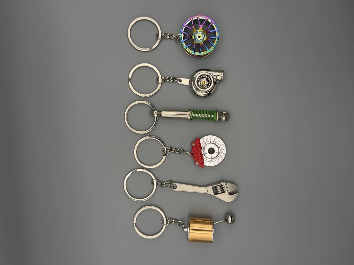 Six SHOP GHXST automotive keychains, one from each first-drop collection
